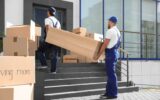 male movers carrying shelving unit male movers carrying shelving unit new house 125849215