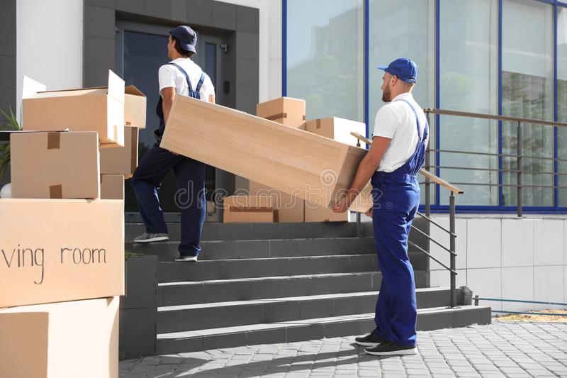 male movers carrying shelving unit male movers carrying shelving unit new house 125849215